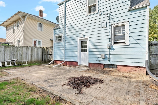 rear view of property with a patio area and a fenced backyard