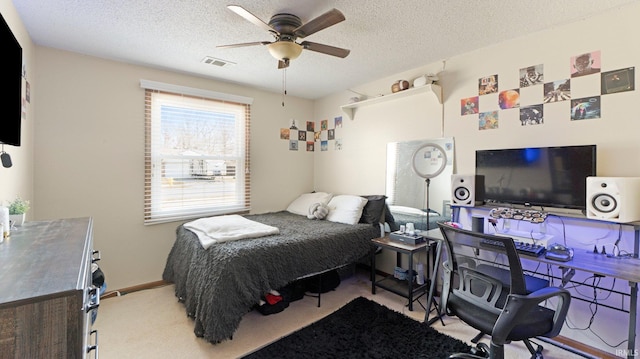 bedroom with visible vents, a textured ceiling, carpet flooring, baseboards, and ceiling fan