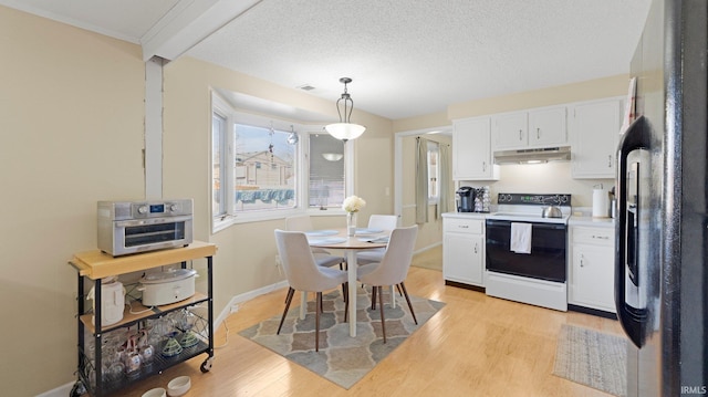 kitchen with light wood finished floors, range with electric cooktop, under cabinet range hood, white cabinetry, and black fridge