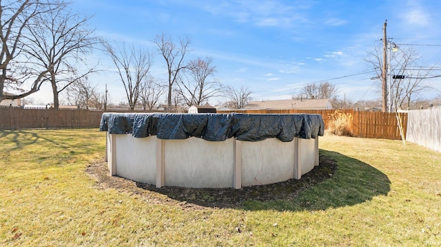 view of pool featuring a yard, a fenced in pool, and a fenced backyard