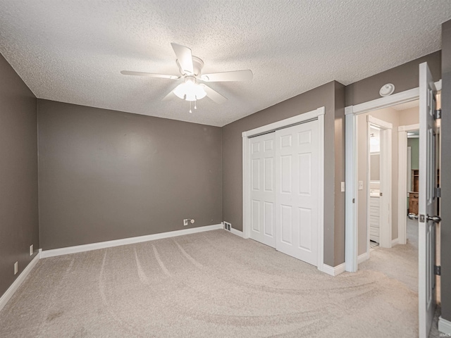 unfurnished bedroom featuring a closet, baseboards, and light colored carpet