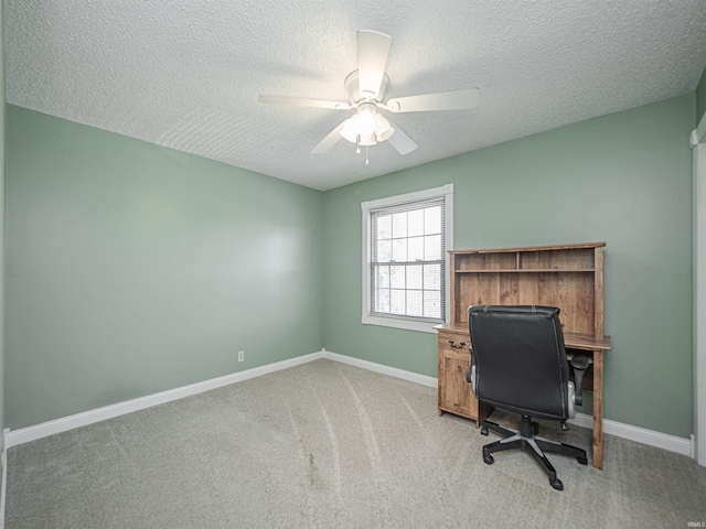 office area with baseboards, light colored carpet, a ceiling fan, and a textured ceiling