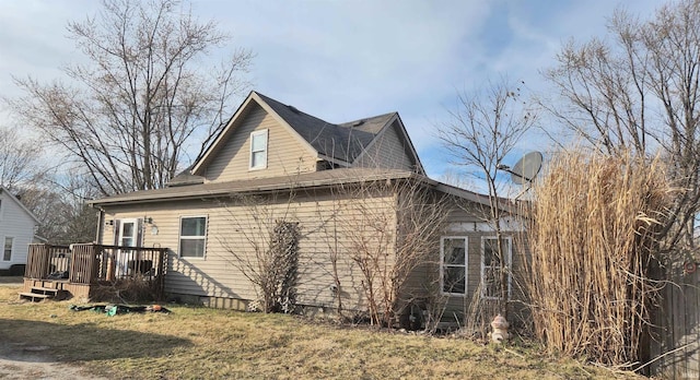 view of home's exterior with a wooden deck