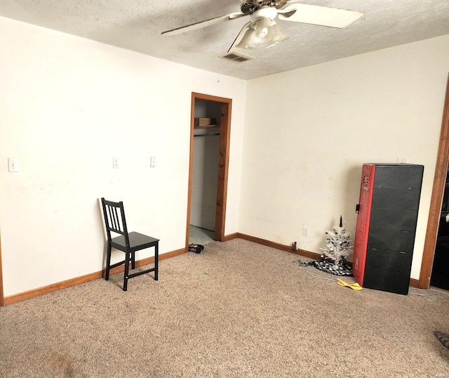 unfurnished bedroom with baseboards, visible vents, a textured ceiling, and carpet