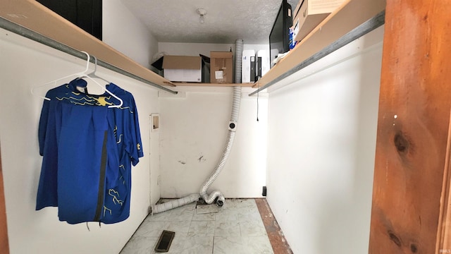 laundry room featuring visible vents, a textured ceiling, hookup for a washing machine, and laundry area