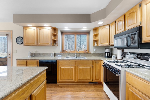 kitchen featuring black appliances, light wood-style flooring, a sink, open shelves, and light stone counters