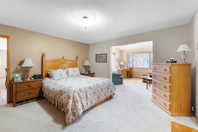 bedroom featuring light carpet