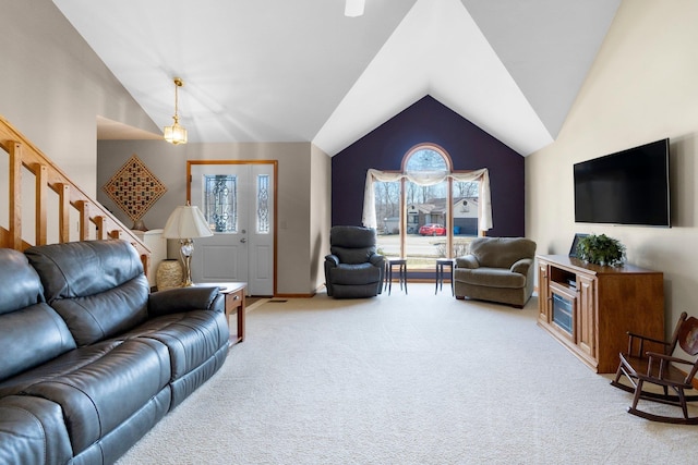 living room featuring baseboards, lofted ceiling, light colored carpet, and stairs