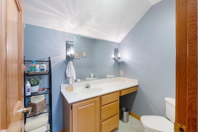 half bathroom featuring vanity, vaulted ceiling, toilet, and baseboards