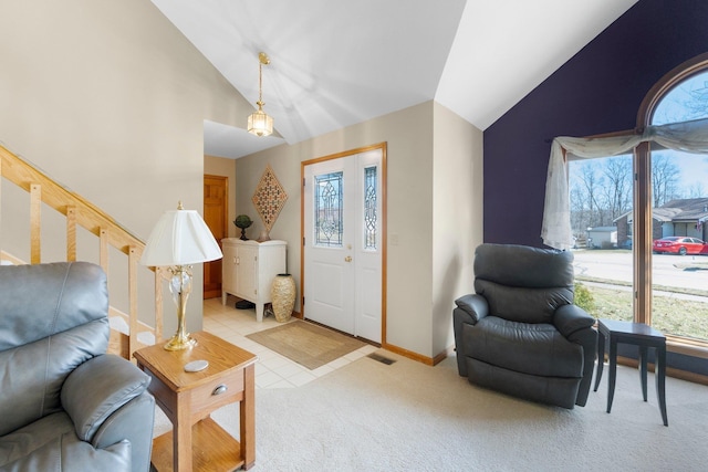 entryway with visible vents, baseboards, stairs, light carpet, and high vaulted ceiling