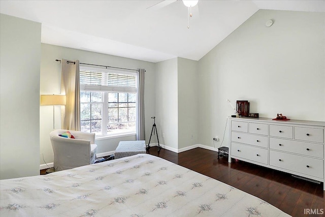 bedroom with lofted ceiling, baseboards, and dark wood-type flooring