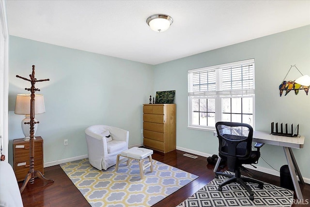 office space featuring visible vents, baseboards, and wood finished floors