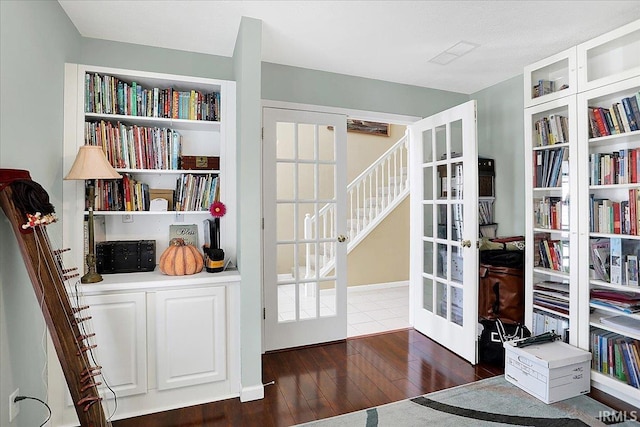 interior space with french doors and hardwood / wood-style floors