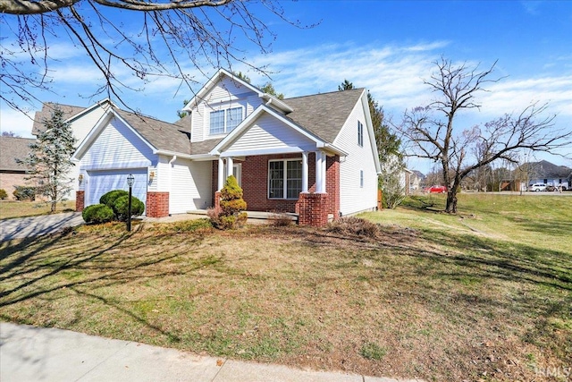 view of front facade with a front yard, an attached garage, and brick siding