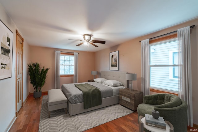 bedroom with baseboards, light wood-style flooring, and a ceiling fan