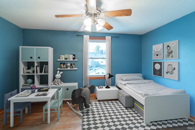 bedroom with a ceiling fan and wood finished floors