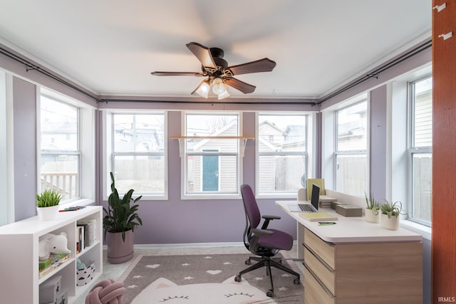 office space featuring baseboards and a ceiling fan