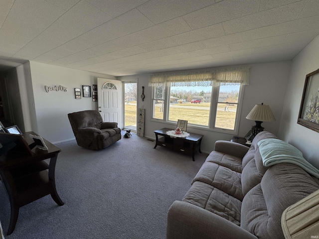 living room with baseboards and carpet