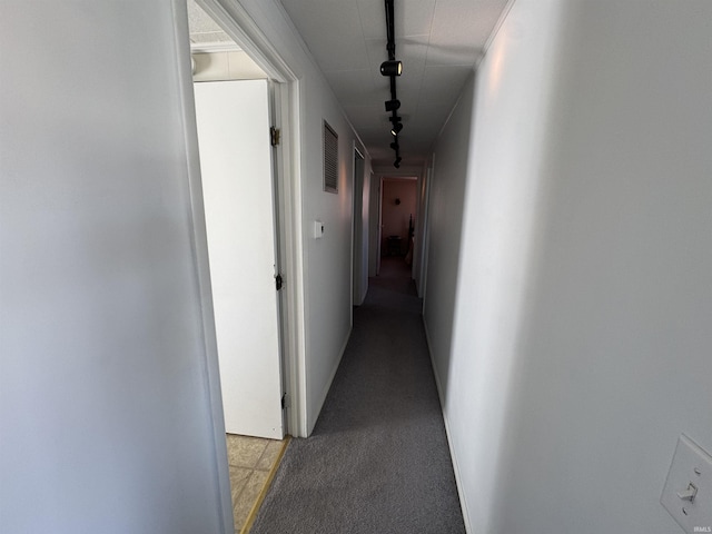 hall with light carpet, track lighting, and visible vents