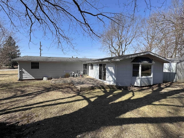 rear view of house featuring a patio and a lawn