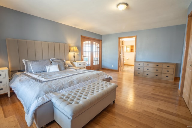 bedroom featuring light wood-style flooring and baseboards