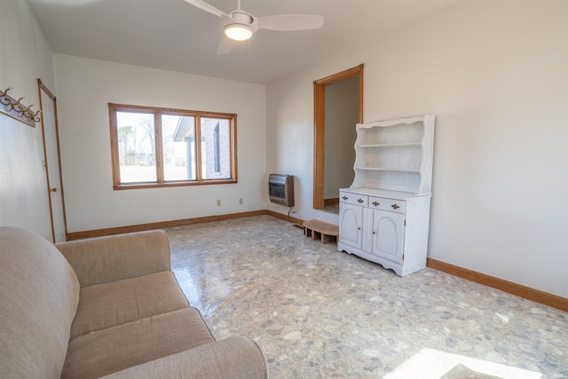 unfurnished living room featuring heating unit, ceiling fan, and baseboards