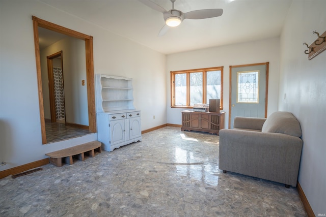 living area featuring visible vents, ceiling fan, and baseboards