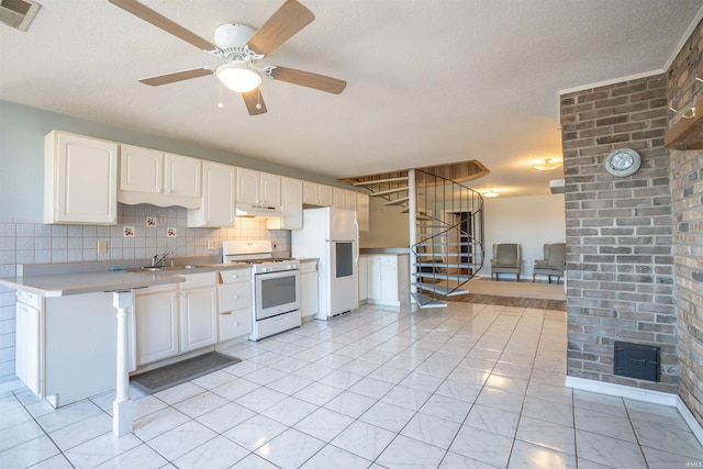 kitchen with visible vents, backsplash, light countertops, white cabinets, and white appliances