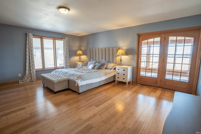 bedroom featuring access to exterior and light wood finished floors