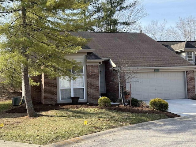 view of front facade with brick siding, an attached garage, concrete driveway, and a front yard