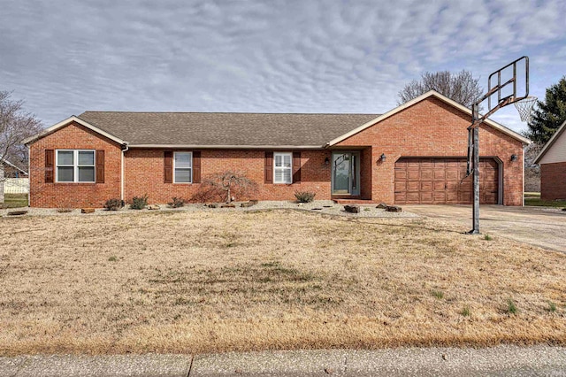 ranch-style house featuring brick siding, a shingled roof, concrete driveway, a front yard, and a garage