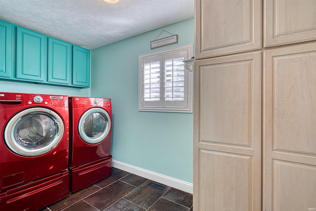 laundry room featuring baseboards, cabinet space, a textured ceiling, and independent washer and dryer