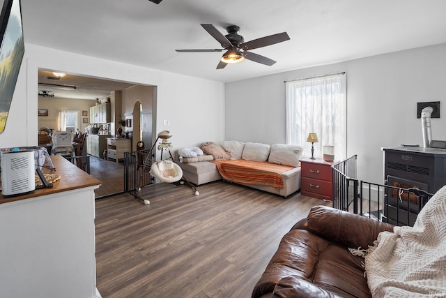 living room featuring ceiling fan, arched walkways, and wood finished floors