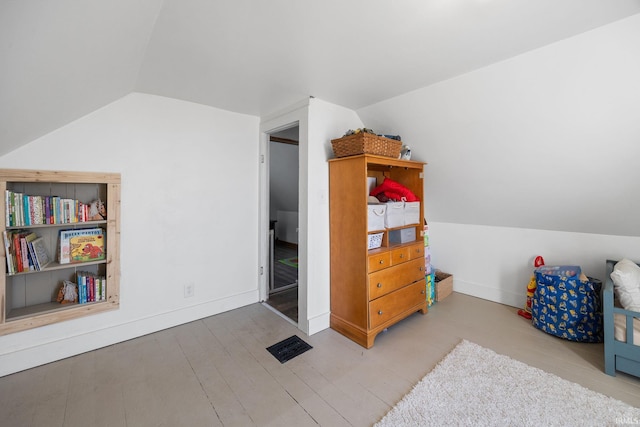 recreation room featuring baseboards, lofted ceiling, and wood finished floors