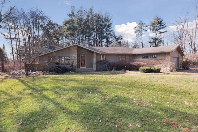 view of front of house with stone siding, an attached garage, a chimney, and a front lawn