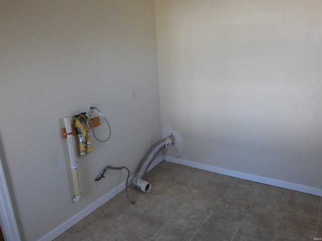 clothes washing area featuring baseboards