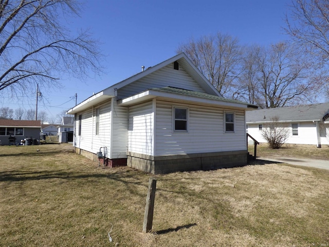 view of side of home featuring a lawn