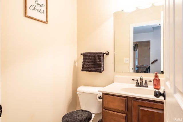 half bath featuring toilet and vanity