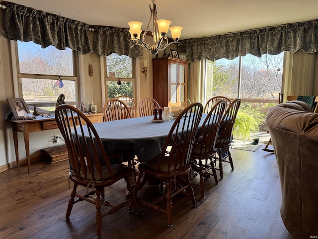 dining area featuring a wealth of natural light, dark wood-type flooring, and a chandelier