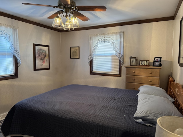 bedroom with multiple windows, ornamental molding, and a ceiling fan