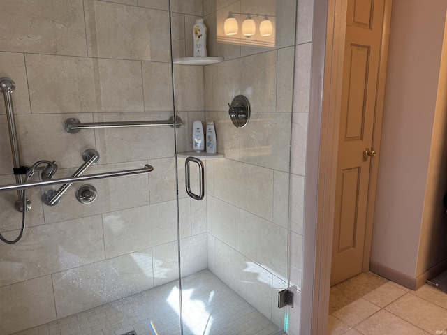 bathroom with tile patterned flooring and a stall shower