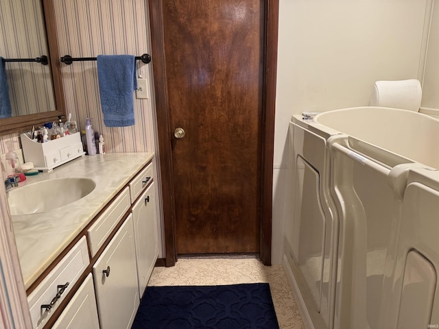 full bath featuring washer and dryer and vanity