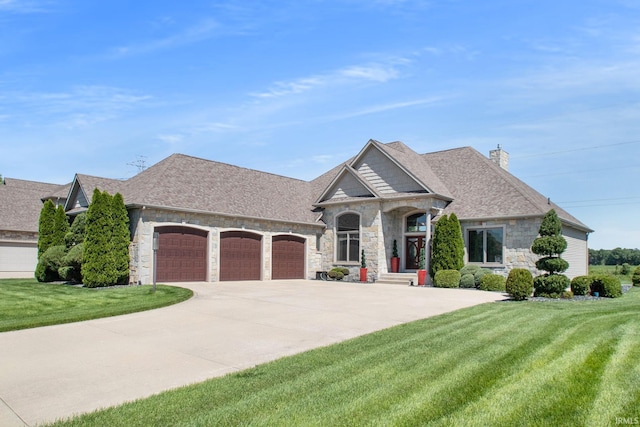 view of front of property featuring a front yard, driveway, a chimney, stone siding, and a garage