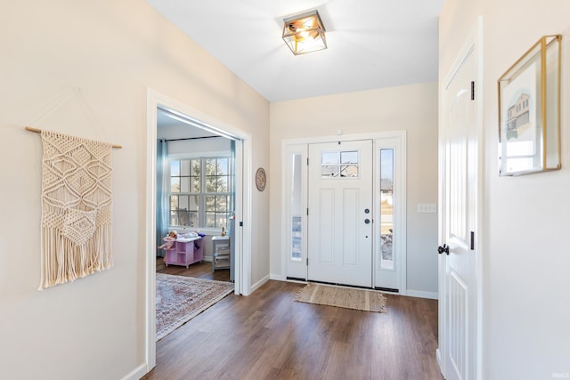 entrance foyer featuring baseboards and dark wood-type flooring