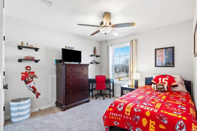 carpeted bedroom with a ceiling fan and baseboards