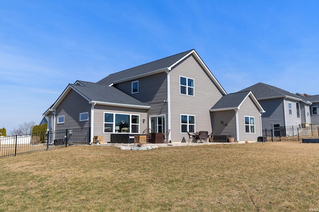 back of house featuring a fenced backyard, a lawn, and a patio