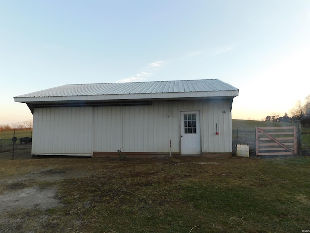 view of outdoor structure featuring an outbuilding and fence