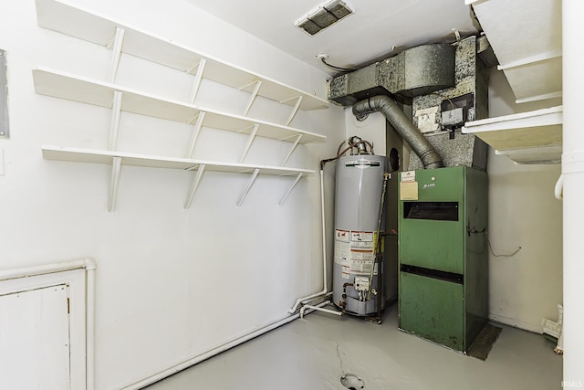 utility room featuring visible vents and water heater