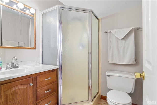 bathroom with toilet, a stall shower, and vanity