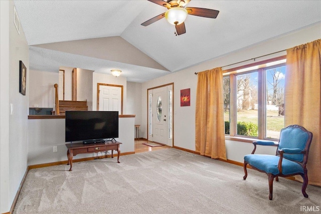 sitting room with vaulted ceiling, a ceiling fan, baseboards, and carpet floors